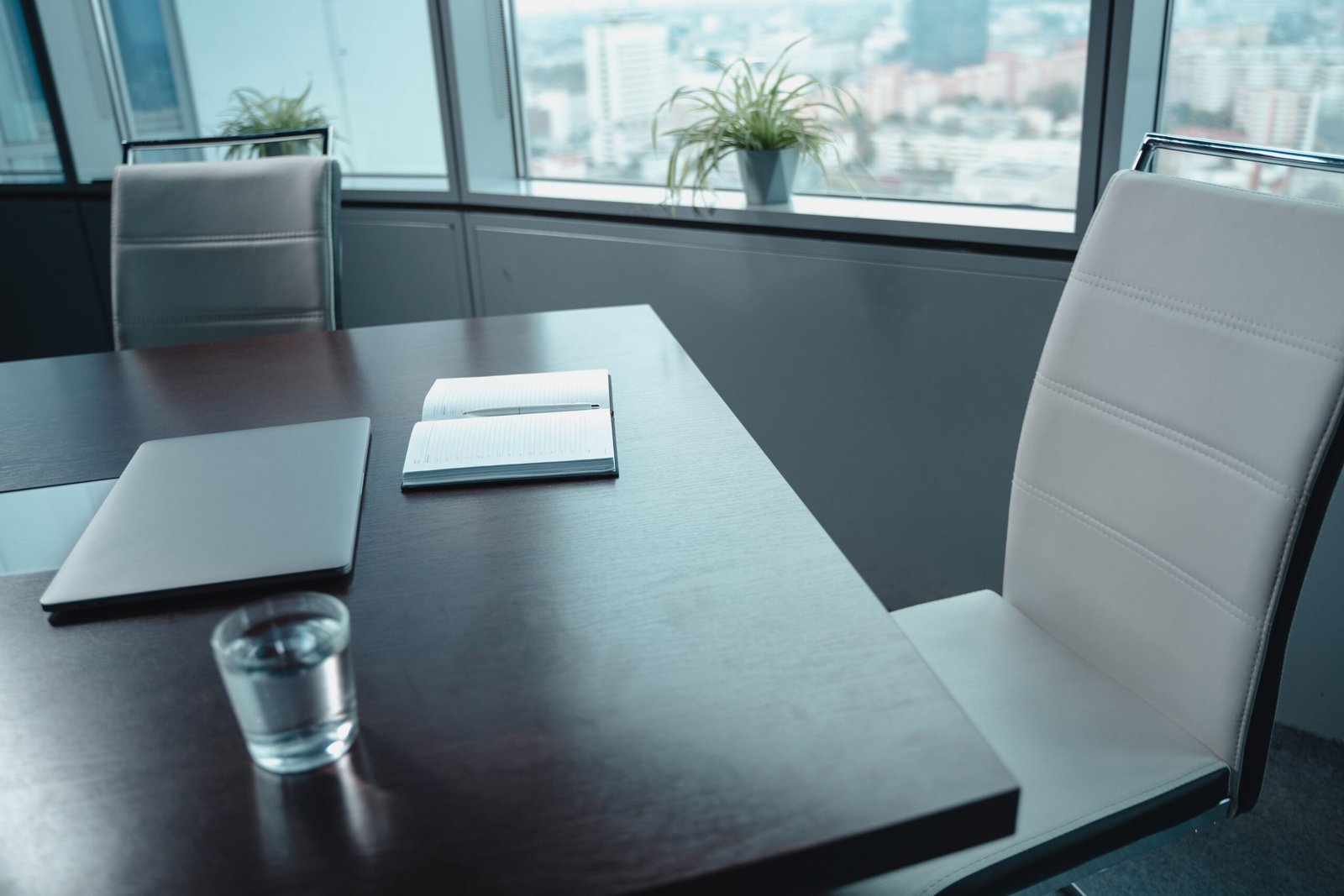 Sala de juntas luminosa con una mesa de trabajo y vista a la ciudad